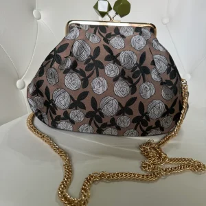 Borsa clutch in tessuto jacquard con fiori beige